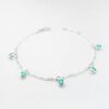 a silver bracelet with turquoise beads and charms