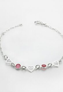 a silver bracelet with hearts and two red stones