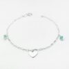 a silver bracelet with a heart charm