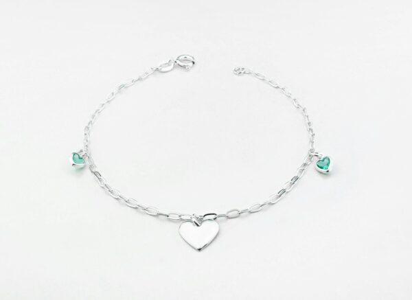 a silver bracelet with a heart charm
